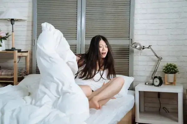 Image of woman getting up because of nighttime leaks Swansea